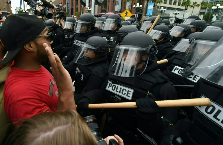 A protester argues with police during a rally against Republican presidential candidate Donald Trump outside his event in San Diego, California, on May 27, 2016