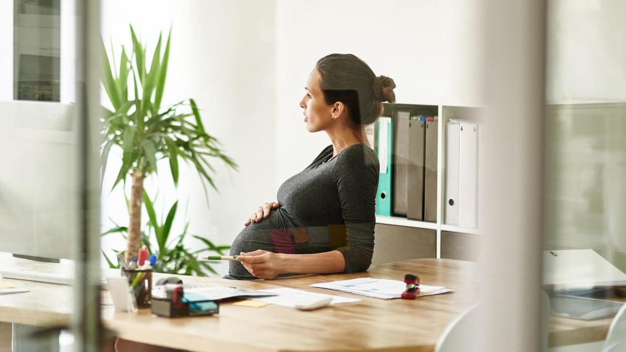 pregnant businesswoman sitting in her office