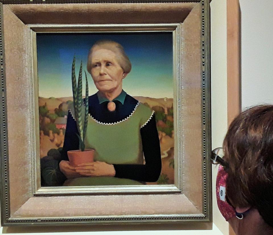 This portrait of Grant Wood’s mother painted in 1929 was one of his first in the Regionalist style for which he became famous. Titled simply “Woman with Plants”, it was among more than 100 of his works on special exhibit at the Cedar Rapids Museum of Art in 2021.