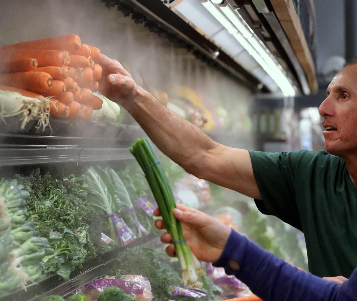 File photo - In 2020, Sprouts Farmers Market employees arrange produce at the Redding store.