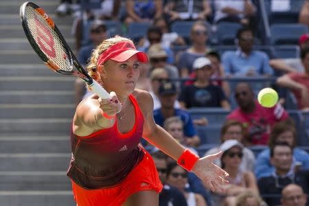 Kristina Mladenovic of France returns a shot to Roberta Vinci of Italy during their quarterfinals match at the U.S. Open Championships tennis tournament in New York, September 8, 2015. REUTERS/Adrees Latif