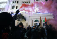 People attend an anti-Boris Johnson demonstration, in central London, Friday Dec. 13, 2019. Boris Johnson's gamble on early elections paid off as voters gave the UK prime minister a commanding majority to take the country out of the European Union by the end of January, a decisive result after more than three years of stalemate over Brexit. (AP Photo/Kirsty Wigglesworth)