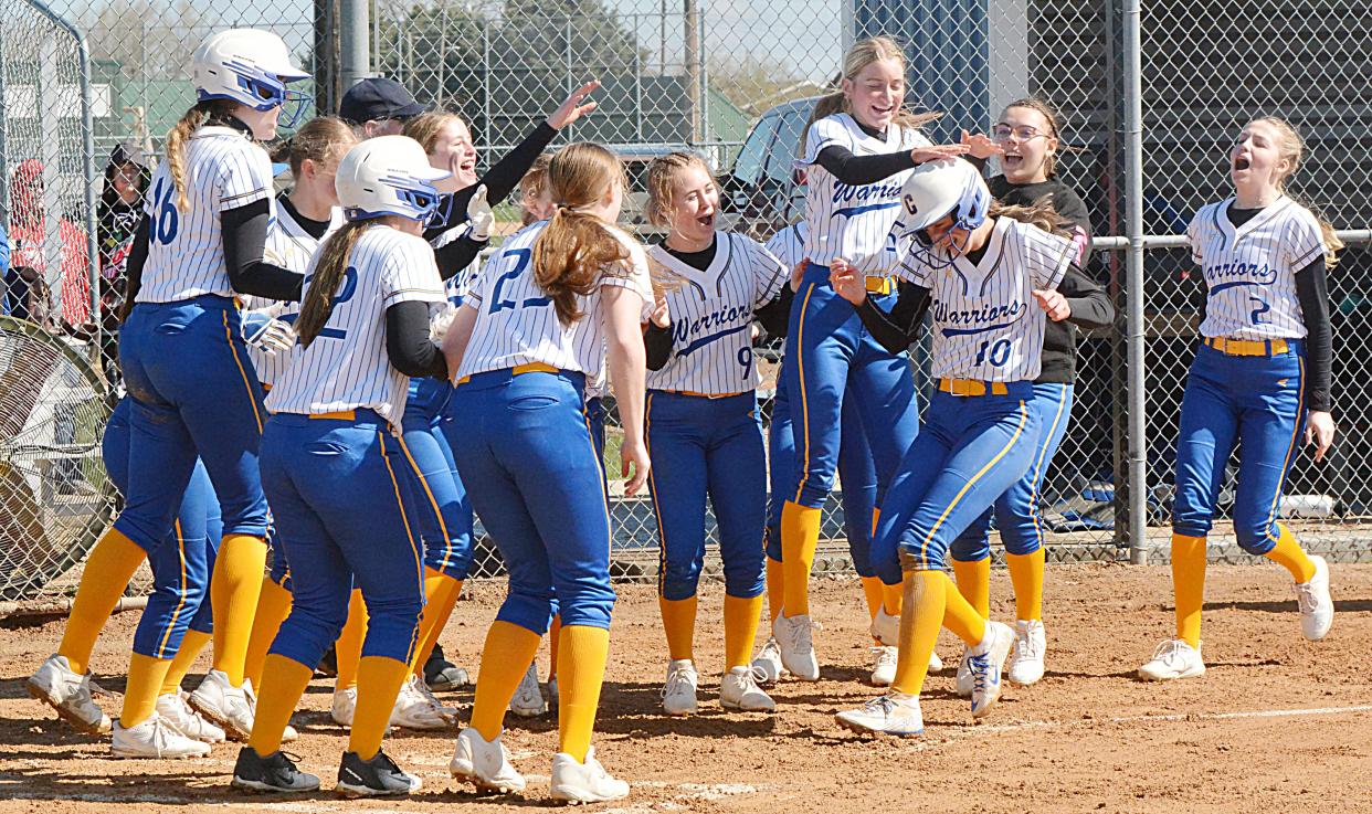 Castewood teammates welcome homer Cydni Kudrna after she drilled a solo homer during a high school fastpitch tripleheader on Saturday, May 4, 2024 in Castlewood.