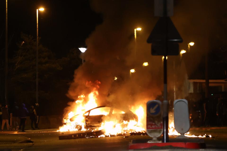 <p>A car burns near Sperrin Park, Waterside, Derry on Monday evening</p> (PA)