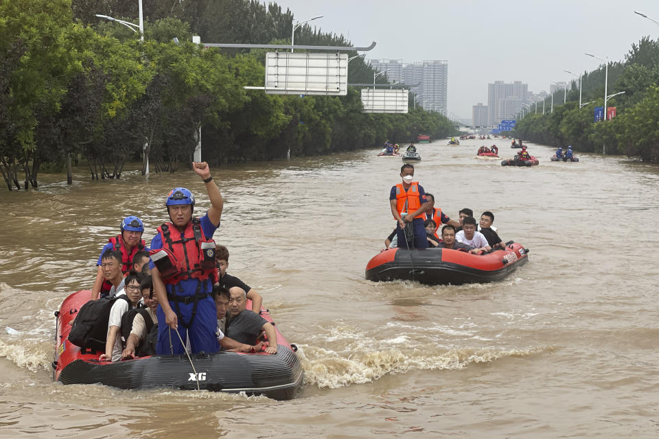 Residents are evacuated by rubber boats through flood waters in Zhuozhou in northern China's Hebei province, south of Beijing, Wednesday, Aug. 2, 2023. China's capital has recorded its heaviest rainfall in at least 140 years over the past few days. (AP Photo/Andy Wong)