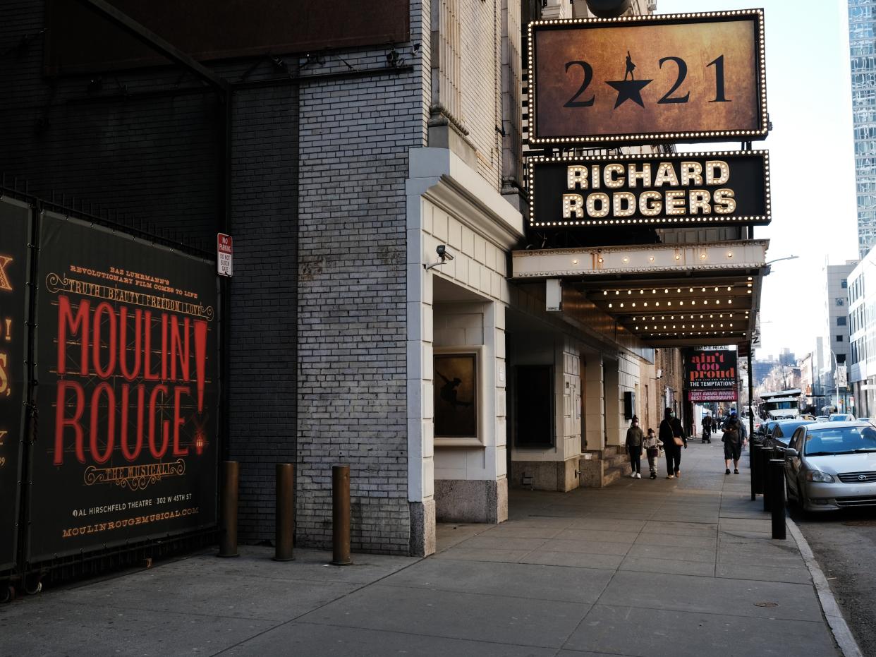 People walk through the empty Broadway theater district one year after it was closed due to Covid-19 restrictions on 12 March 2021 in New York City (Spencer Platt/Getty Images)