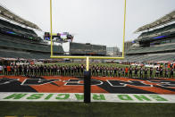 The Cincinnati Bengals stand arm in arm as "Lift Every Voice and Sing" is played before an NFL football game between the Cincinnati Bengals and the Los Angeles Chargers, Sunday, Sept. 13, 2020, in Cincinnati. (AP Photo/Bryan Woolston)