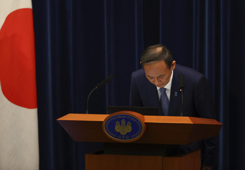 Japan's Prime Minister Yoshihide Suga bows as he attends a news conference on Japan's response to the coronavirus pandemic at his official residence during the Tokyo 2020 Olympic Games in Tokyo, Japan, Friday, July 30, 2021. Suga expanded a coronavirus state of emergency to four more areas in addition to Tokyo on Friday following record spikes in infections as the capital hosts the Olympics. (Issei Kato/Pool Photo via AP)