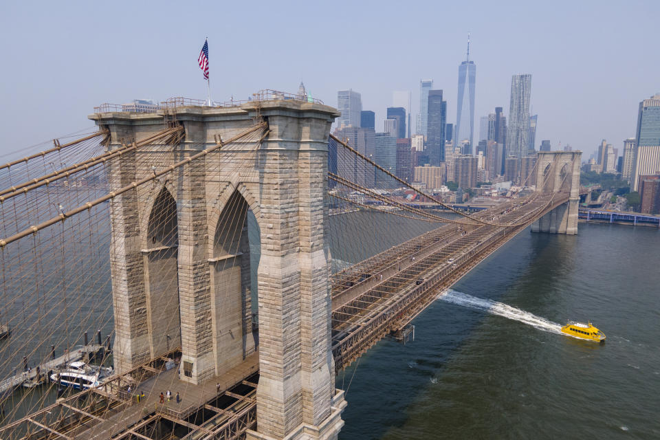 The Brooklyn Bridge, One World Trade Center and the lower Manhattan skyline are visible in New York on Thursday, June 8, 2023. With weather systems expected to hardly budge, the smoky blanket billowing across the U.S. and Canada from wildfires in Quebec and Nova Scotia should persist into Thursday and possibly the weekend. (AP Photo/Ted Shaffrey)