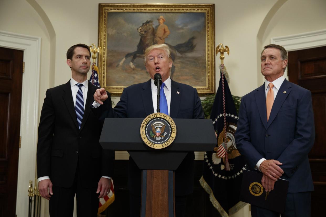 President Donald Trump, flanked by Senator Tom Cotton Senator David Perdue, speaks in the Roosevelt Room of the White House in Washington: AP