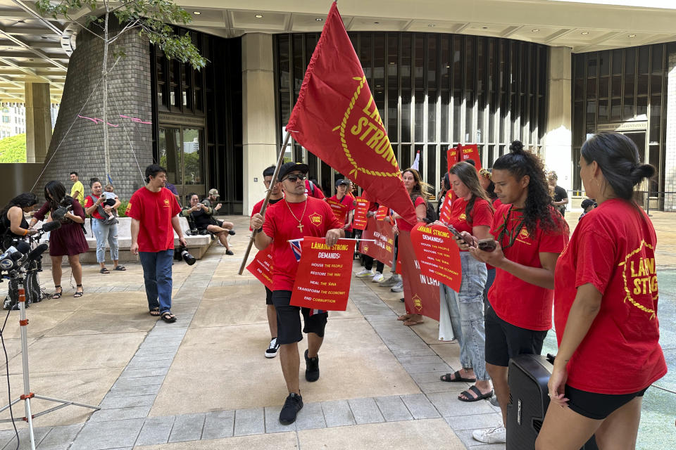 Supporters of the group Lahaina Strong gather for a rally at the Hawaii State Capitol on Wednesday, Jan. 17, 2024, in Honolulu. Hawaii lawmakers on Wednesday opened a new session of the state Legislature vowing to address glaring problems laid bare by the deadly wildfire that destroyed the historic town of Lahaina in August: the threat posed by wildfires and the lack of affordable housing. (AP Photo/Audrey McAvoy)