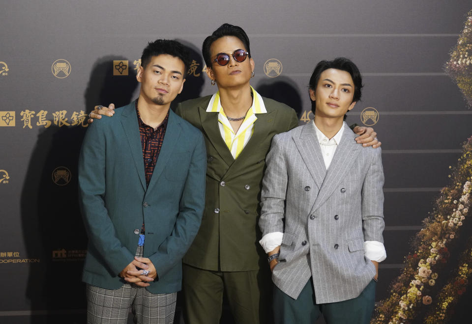 Taiwanese pop group ''EggPlantEgg'' pose as they arrive for the 31th Golden Melody Awards in Taipei, Taiwan, Saturday, Oct. 3, 2020. The awards show, one of the world's biggest Chinese-language pop music annual events was postponed from June to Oct. due to the coronavirus pandemic. (AP Photo/Billy Dai)