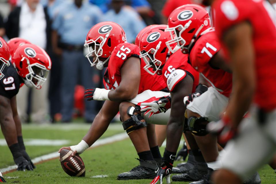 Georgia offensive lineman Jared Wilson (55) gets set to snap the ball during the G-Day spring football game in Athens, Ga., on Saturday, April 16, 2022. The black team won 26-23.