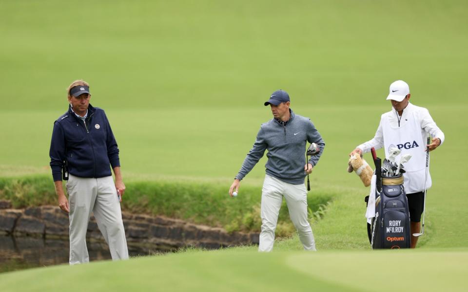 Rory McIlroy of Northern Ireland talks with a rules official on the seventh hole  - GETTY IMAGES