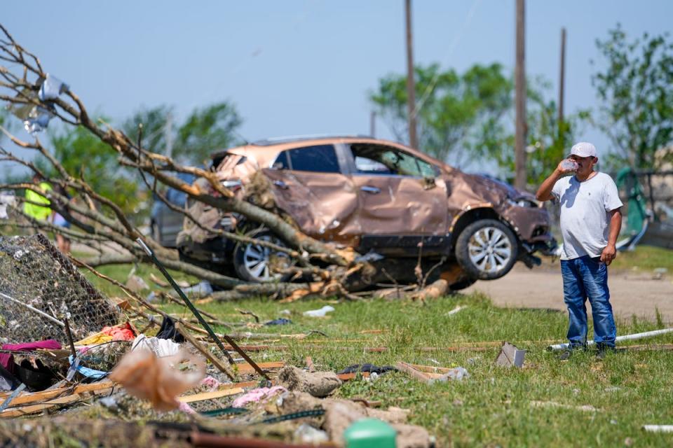 A man surveys damage to a neighbor's home after a deadly tornado rolled through, Sunday, May 26, 2024, in Valley View, Texas (AP)