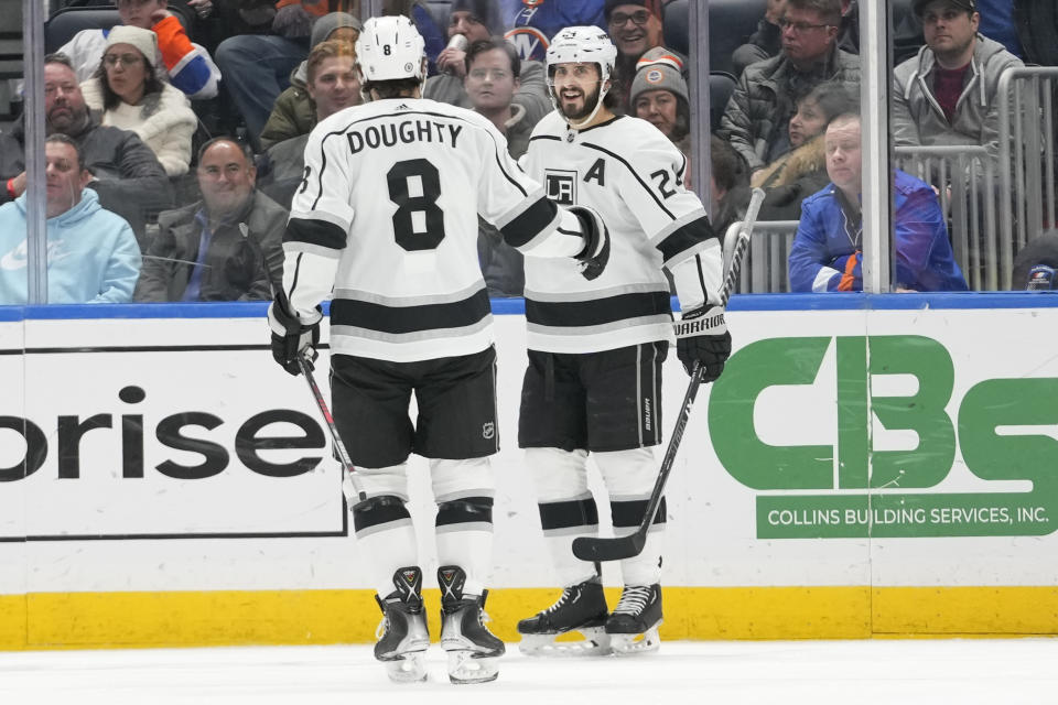 Los Angeles Kings center Phillip Danault (24) celebrates with defenseman Drew Doughty (8) after scoring against the New York Islanders during the second period of an NHL hockey game Friday, Feb. 24, 2023, in Elmont, N.Y. (AP Photo/Mary Altaffer)