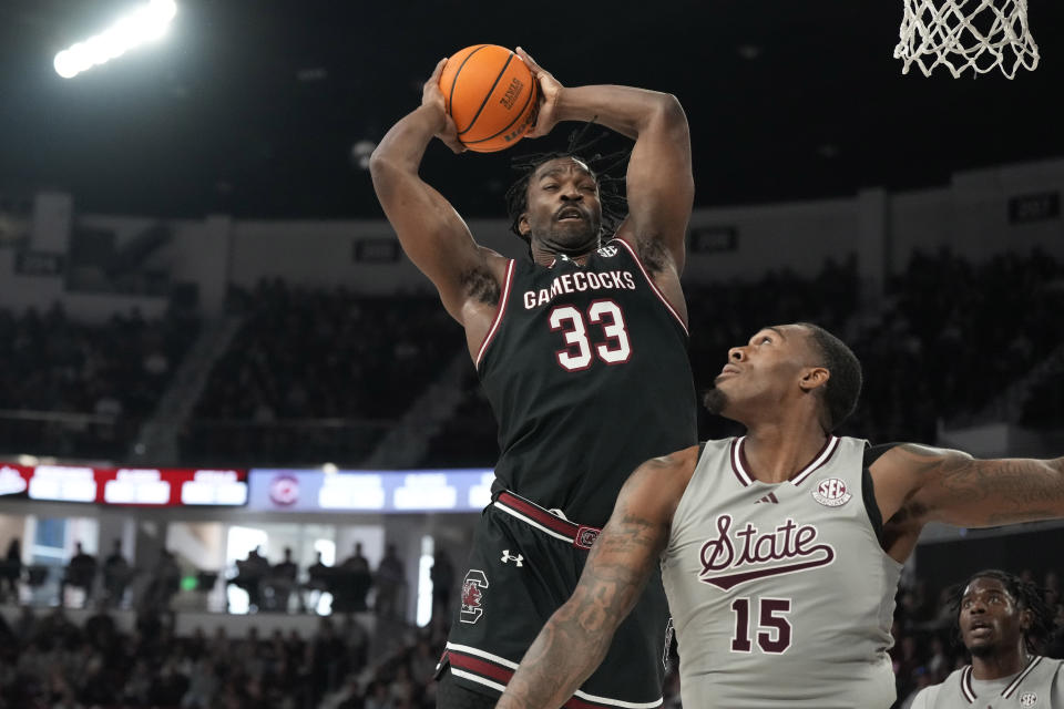 South Carolina forward Josh Gray (33) pulls down a rebound over Mississippi State forward Jimmy Bell Jr. (15) during the first half of an NCAA college basketball game, Saturday, March 9, 2024, in Starkville, Miss. South Carolina won in overtime 93-89. (AP Photo/Rogelio V. Solis)