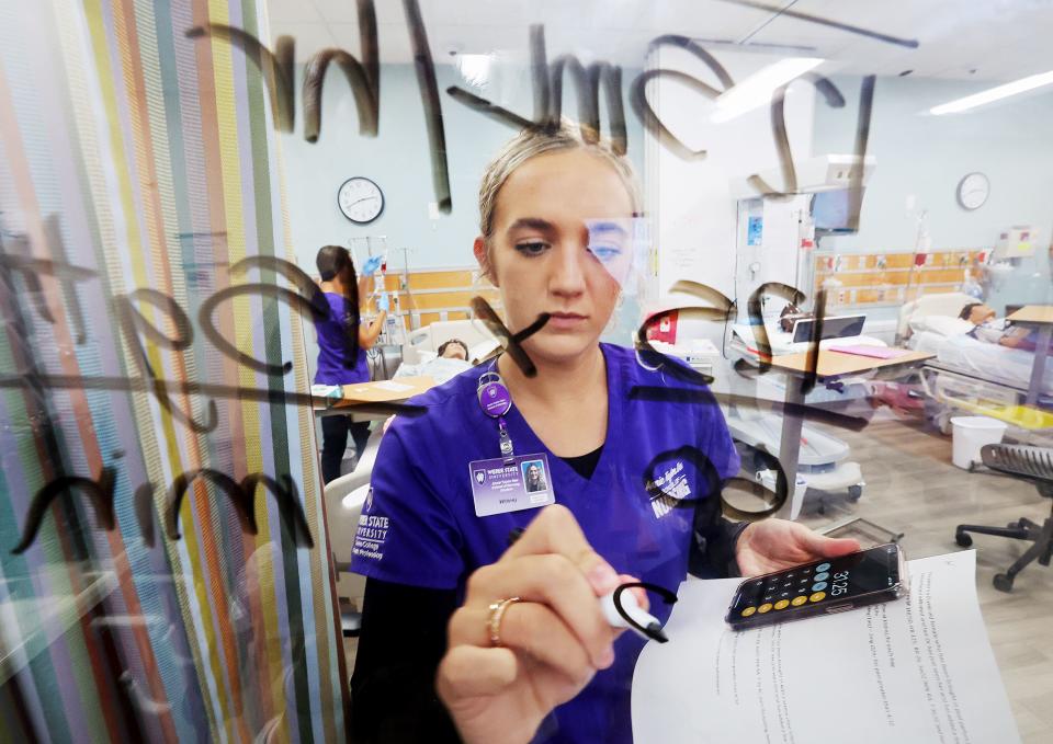 Nursing student Whitney Weston works out a few mathematical problems as she and other students go about their work in the simulation lab in the Marriott Health Building at Weber State University in Ogden on Tuesday, Sept. 5, 2023. | Scott G Winterton, Deseret News