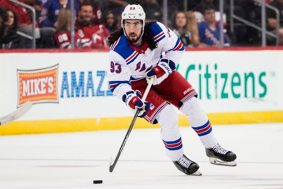 New York Rangers' Mika Zibanejad (93) looks to pass the puck during the first period of the team's NHL preseason hockey game against the New Jersey Devils on Wednesday, Oct. 4, 2023, in Newark, N.J.