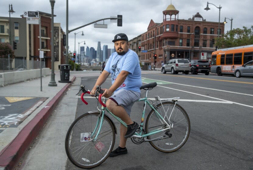 BOYLE HEIGHTS, CA - AUGUST 18, 2021: Erick Huerta, 37, who has been stopped by sheriff's deputies while riding his hybrid road bike, is photographed on 1st St. in Boyle Heights. (Mel Melcon / Los Angeles Times)