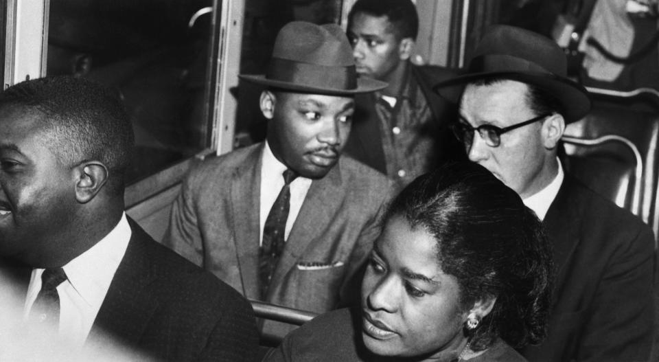 Dr. Martin Luther King, Jr. (center) rides the Montgomery bus with Rev. Glenn Smiley (right) of Texas. In 1955, black activists formed the Montgomery Improvement Association to boycott the segregated transit system and chose Dr. King as their leader. A year later, the African Americans of Montgomery, Alabama, achieved their goal of desegregation of the city's buses.