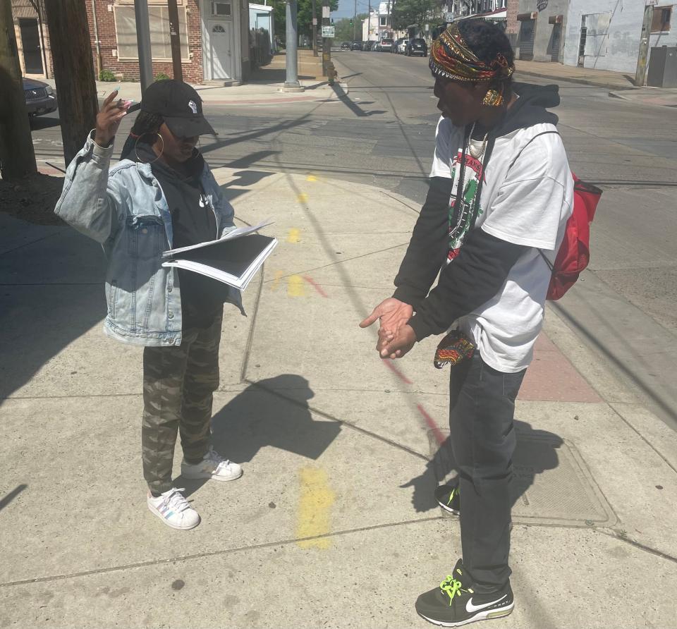 James Albert Flowers, an activist in Southbridge, asking a resident to sign his petition, which expressed disapproval of construction work that shut down the community for nearly three weeks.