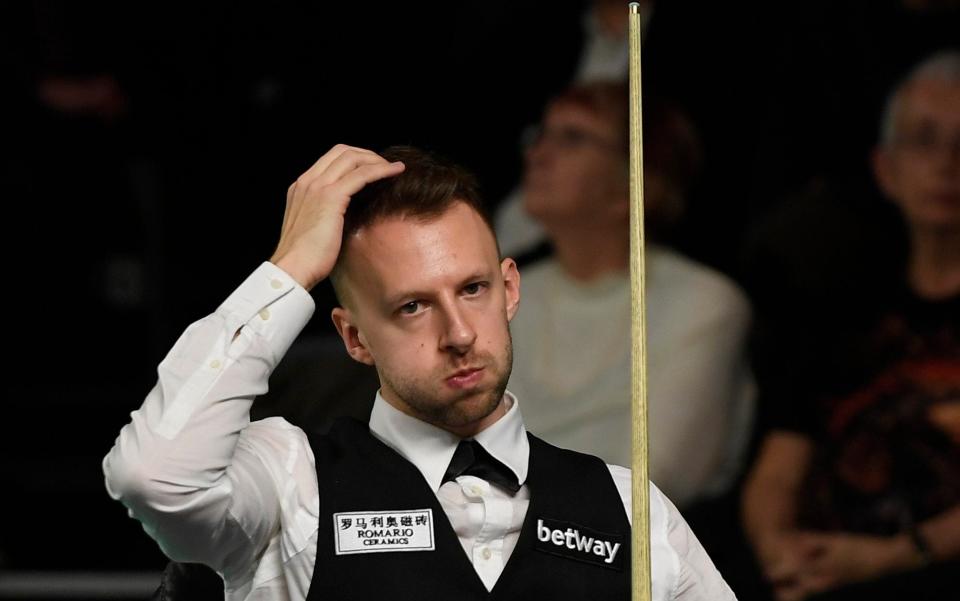 Judd Trump looks disconsolate as he watches on - Getty Images Europe