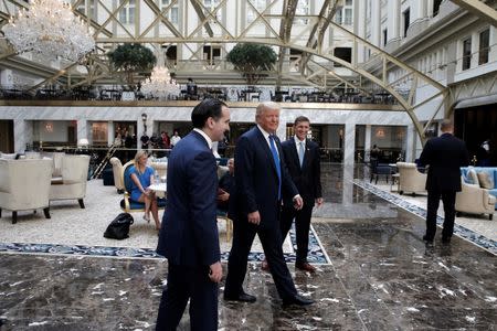 Republican presidential nominee Donald Trump walks through the atrium of his new Trump International Hotel in Washington, D.C., U.S., September 16, 2016. REUTERS/Mike Segar