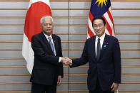 Japan's Prime Minister Fumio Kishida, right, and Malaysian Prime Minister Ismail Sabri Yaakob, left, shake hands at the start of their meeting at the Prime Minister's official residence Friday, May 27, 2022 in Tokyo. (AP Photo/Eugene Hoshiko, Pool)