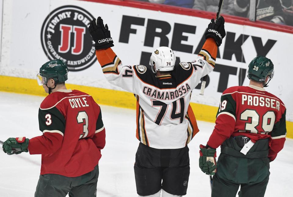 Anaheim Ducks' Joseph Cramarossa (74) celebrates his goal between Minnesota Wild's Charlie Coyle (3) and Nate Prosser, right in the first period of an NHL hockey game, Tuesday, Feb. 14, 2017, in St. Paul, Minn. (AP Photo/Tom Olmscheid)