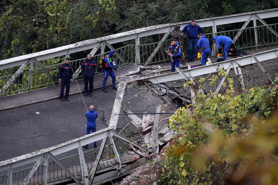 Picture of rescue workers on the collapsed bridge, where two people died on Monday in Southern France.