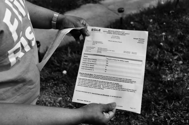 Nayyirah Shariff holds a document from the Michigan Department of Environment that that shows her home's lead level in water as three to four times the federal limits.