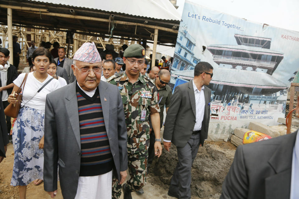 Nepal Prime Minister Khadga Prasad Oli, front left, inspects the reconstruction of the Kasthamandap temple which collapsed in the 2015 earthquake, during a function to mark the anniversary of the quake in Kathmandu, Nepal, Thursday, April 25, 2019. The violence of the 7.8-magnitude earthquake killed nearly 9,000 people and left countless towns and villages across central Nepal in shambles. (AP Photo/Niranjan Shrestha)