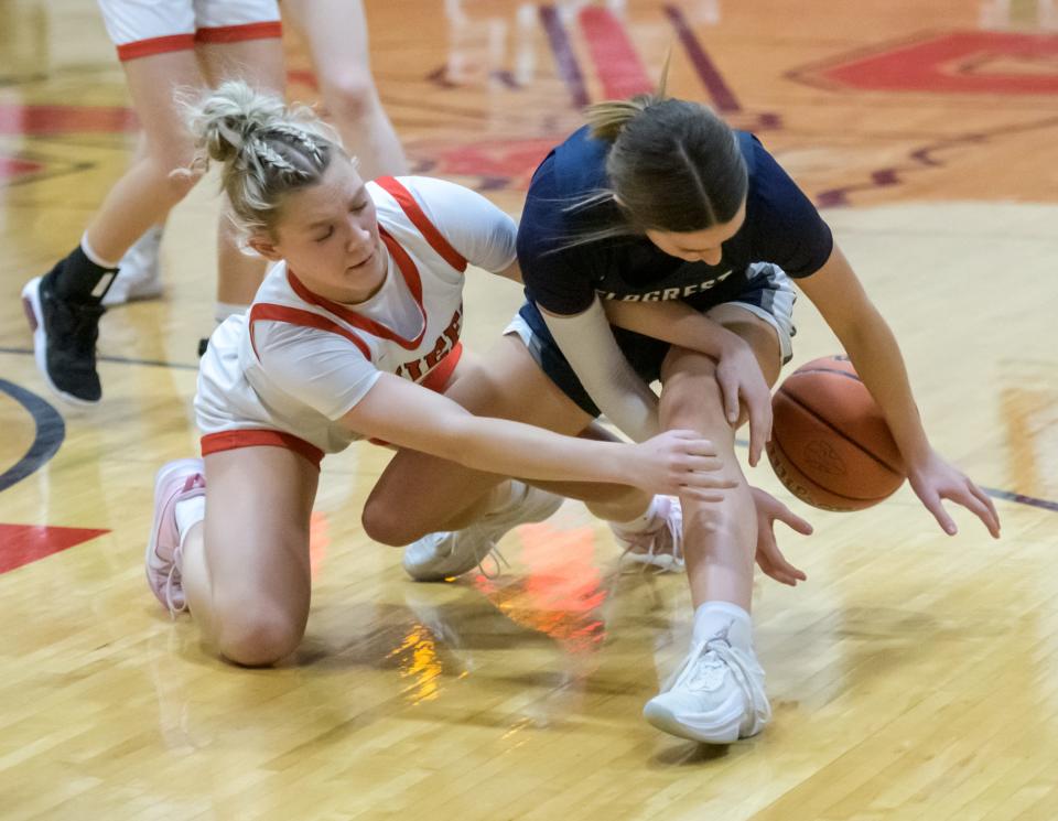 Dee-Mack's Addison Swadinsky, left, and Fieldcrest's Kaitlin White tangle over a loose ball in the second half Thursday, Feb. 2, 2023 in Mackinaw. The Knights defeated the Chiefs 62-54.