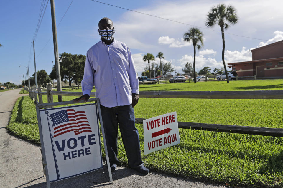 William Freeman, 51, poses for a photograph outside of his polling station, Monday, Aug. 10, 2020, in Riviera Beach, Fla. Freeman recently registered to vote after serving three years for grand theft, his fourth prison stint. (AP Photo/Lynne Sladky)