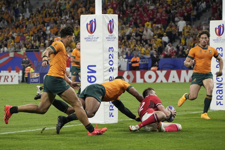 Wales' Nick Tompkins scores a try against Australia during a Rugby World Cup Pool C match at the Parc OL stadium in Lyon, France, Sunday, Sept. 24, 2023. (AP Photo/Laurent Cipriani)