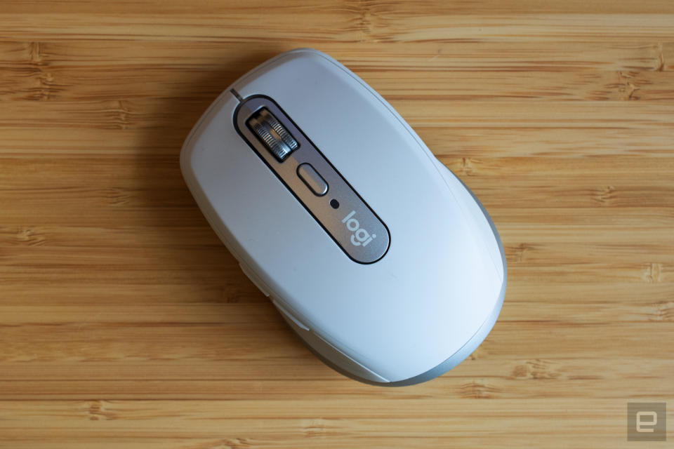 The Logitech MX Anywhere 3 mouse on a wooden table.