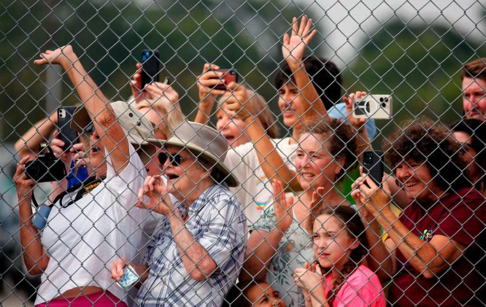 Supporters of former president Donald Trump wave as he boards a plane at the Columbus Airport to leave Columbus, Georgia. 06/10/2023 Mike Haskey/mhaskey@ledger-enquirer.com