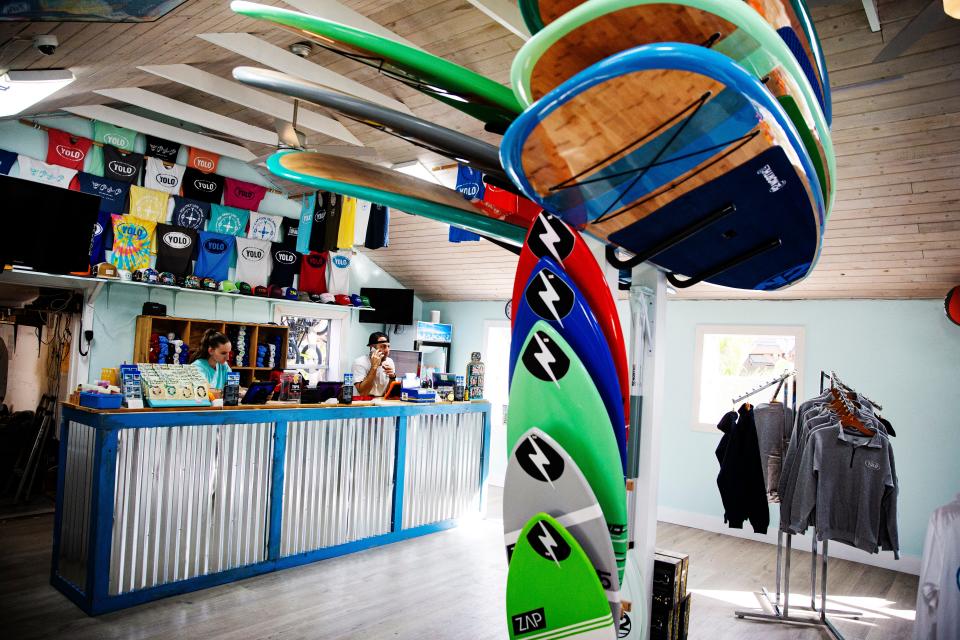 Mike Zanolli and Nikki Hinks work in the recently re-opened YOLO Water Sports building on Andy Rosse Lane on Captiva on Wednesday, Jan. 4, 2023. It is one the few businesses back open since Hurricane Ian slammed the island. 