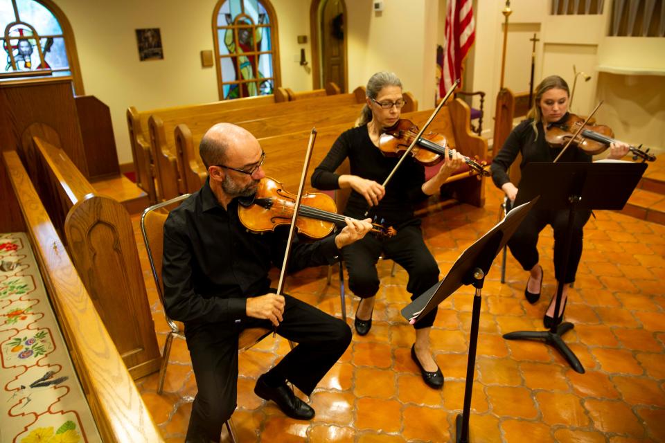 Violinists Boris Sandler, Susan Sikuta and Brandis Godwin practice during the Camerata of Naples rehearsal, Wednesday, Dec. 15, 2021, at St. John's Episcopal Church in Naples, Fla.