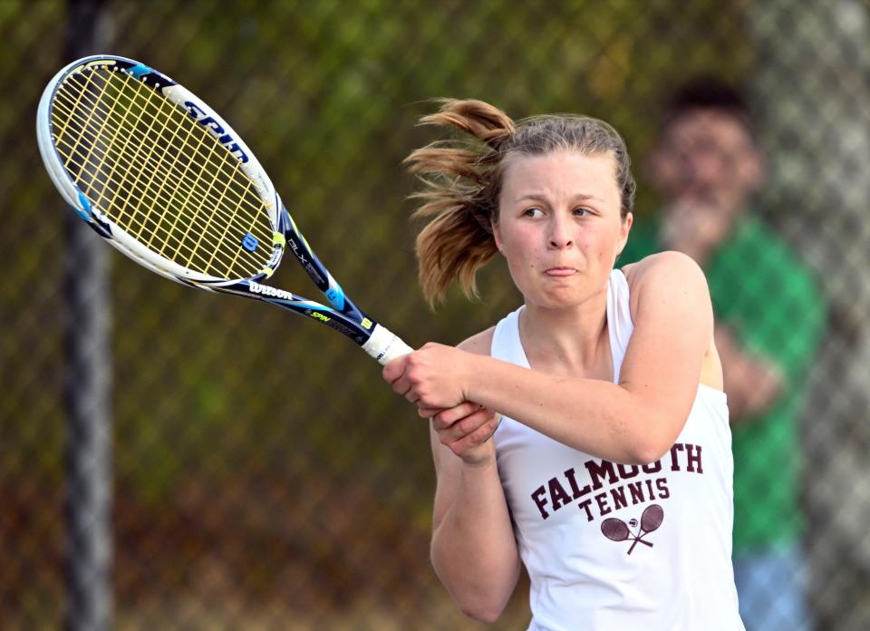 Falmouth number one singles player Caroline Moskal follows through on a backhand to return a shot at her Barnstable opponent Sophie Davis.