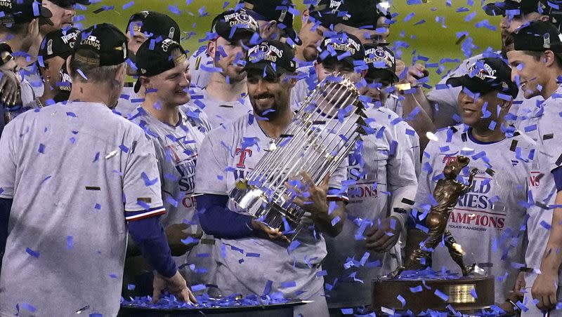 Texas Rangers’ Marcus Semien holds the trophy as the Texas Rangers celebrate after winning Game 5 of the baseball World Series against the Arizona Diamondbacks Wednesday, Nov. 1, 2023, in Phoenix. The Rangers won 5-0 to win the series 4-1.