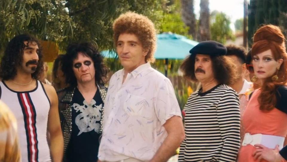 David Dastmalchian as Queen's John Deacon at a pool party full of other celebs in Weird