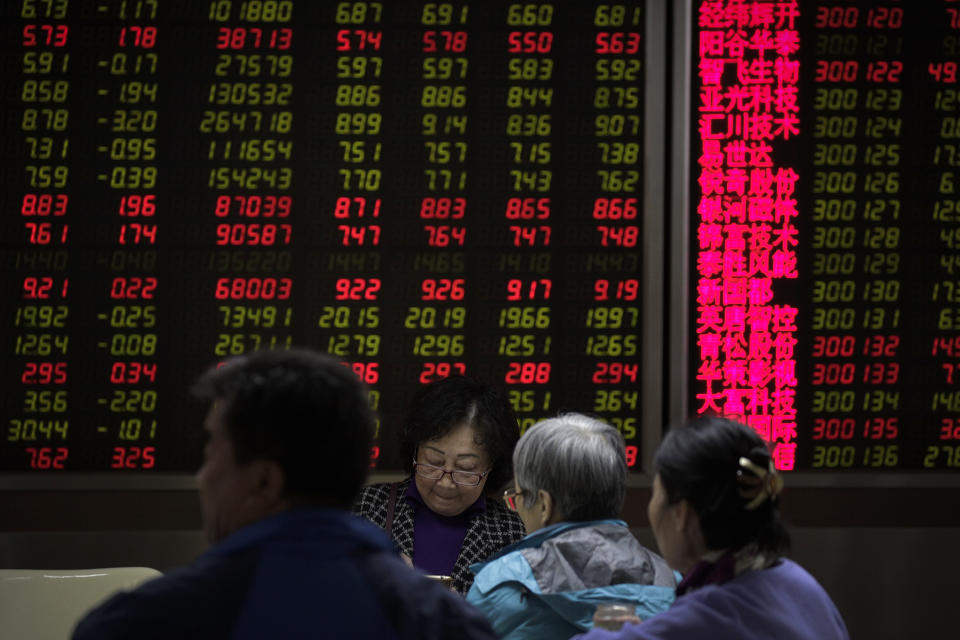 Investors monitor share prices at a brokerage house in Beijing, Wednesday, March 27, 2019. Shares were mixed in Asia early Wednesday after U.S. stocks finished broadly higher on Wall Street, erasing modest losses from a day earlier. (AP Photo/Andy Wong)