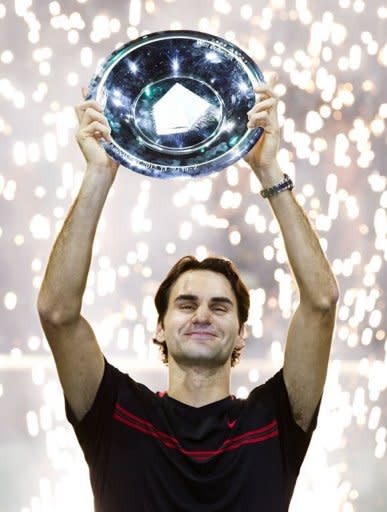 Switzerland's Roger Federer holds the trophy after winning the ABN AMRO Tennis Tournament in Rotterdam. Federer won the final 6-1, 6-4 against Juan Martin de Potro of Argentina