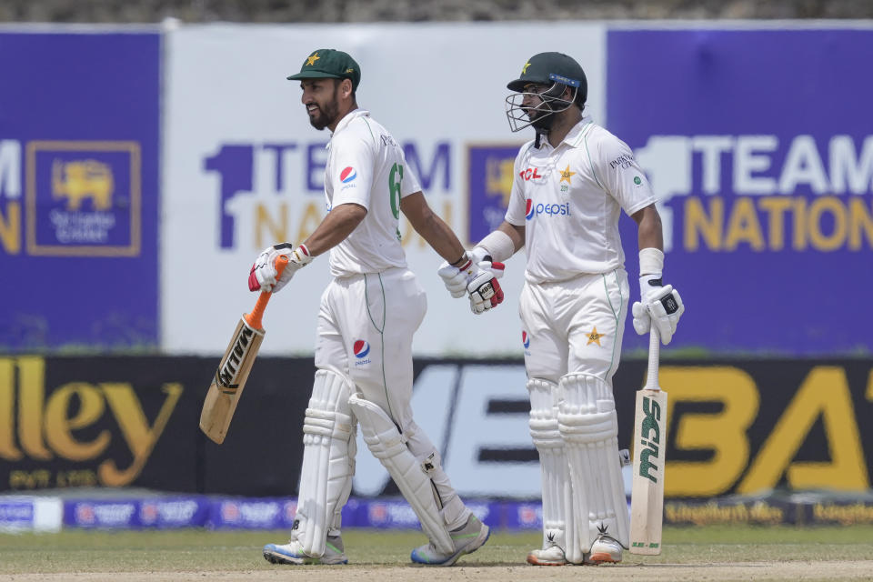 Pakistan's Imam-ul-Haq, right, and Agha Salman shake hands upon their win over Sri Lanka by four wickets in the first cricket test match between Sri Lanka and Pakistan in Galle, Sri Lanka on Thursday, July 20, 2023. (AP Photo/Eranga Jayawardena)