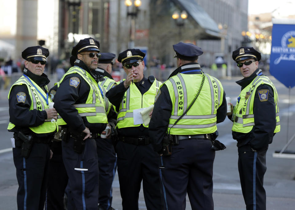 Boston Police officers receive instructions from their supervisor near the finish line before the 118th Boston Marathon Monday, April 21, 2014 in Boston. (AP Photo/Robert F. Bukaty)