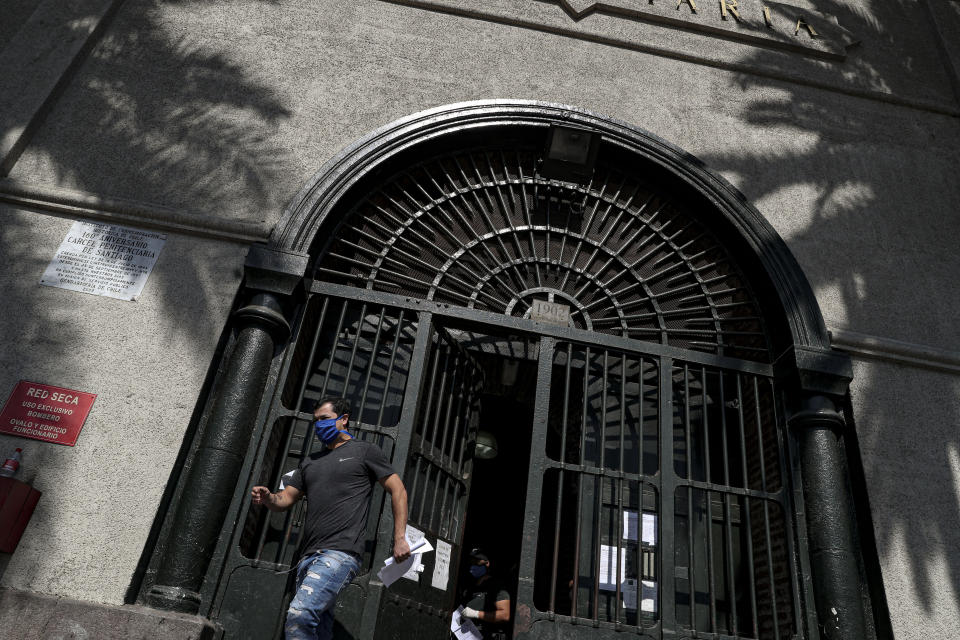 A low-risk inmate leaves the National Penitentiary released under a commutative general pardon as a measure to prevent overcrowding in prisons in an effort to curb the spread of the new coronavirus in Santiago, Chile, Saturday, April 18, 2020. (AP Photo/Esteban Felix)