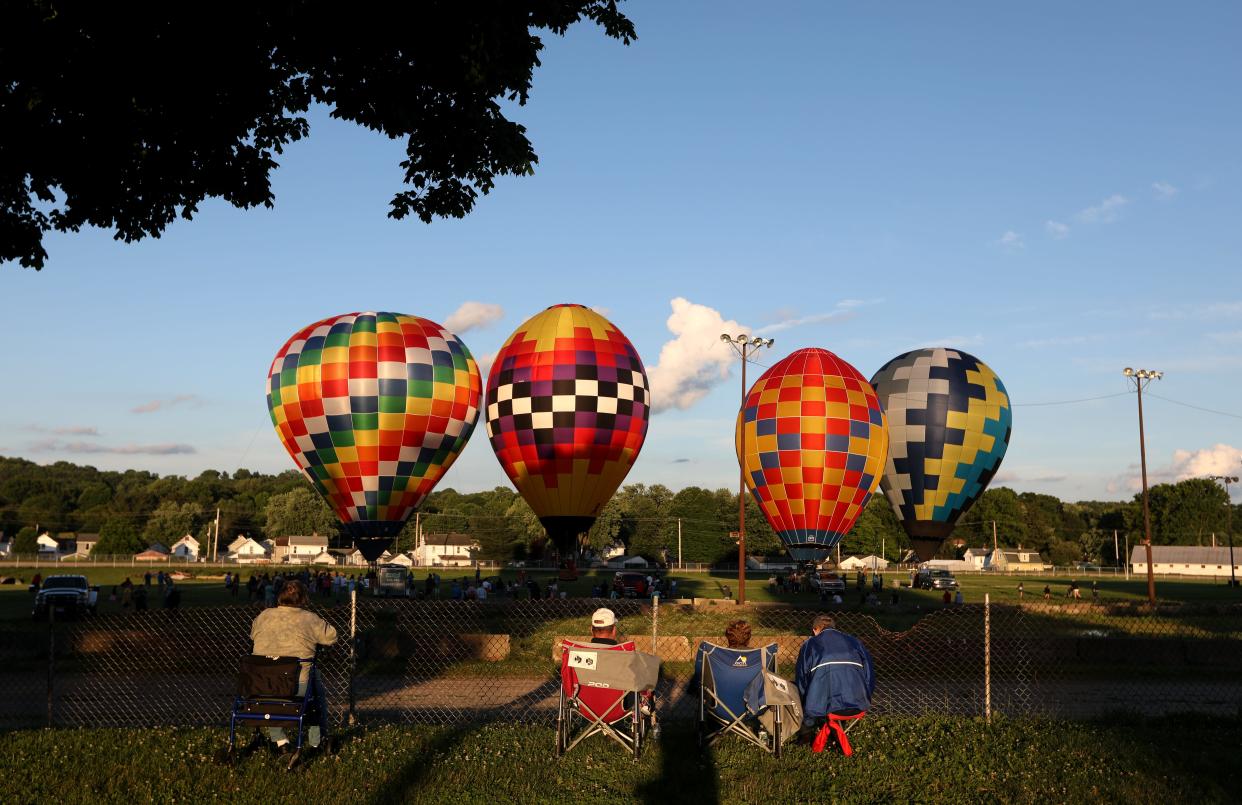 High winds kept balloons on the ground during the first night of the Coshocton Hot Air Balloon Festival, but the winds eventually calmed enough to inflate balloons for the public to enjoy.