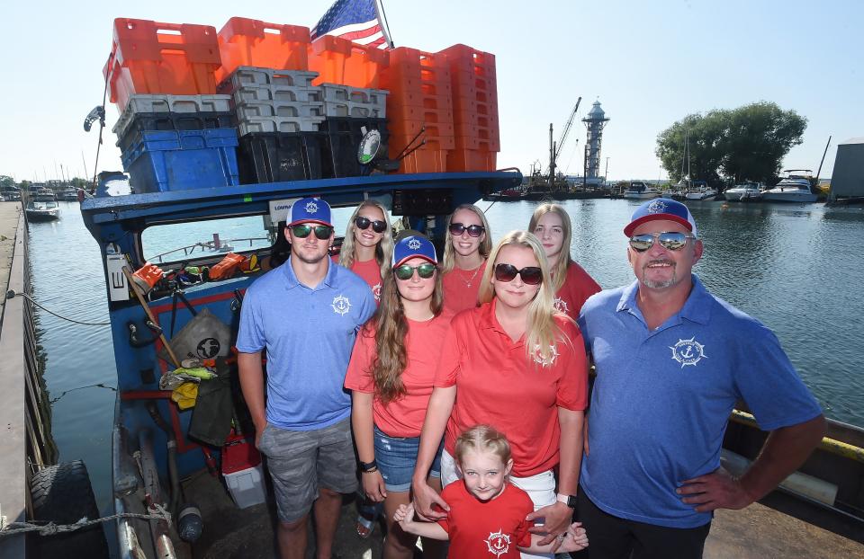 Jim Shaffer, right, owner of Strong Winds Fisheries and Presque Isle Fish & Farm, is shown with family members, on board the Dixie, docked just east of State Street. Helping with the family business are, from left to right, Wyatt Shaffer, Erica Hawes, Emillie Shaffer, Jaelyn Blood, Jodie Shaffer, Ella Shaffer and Jacey Blood.